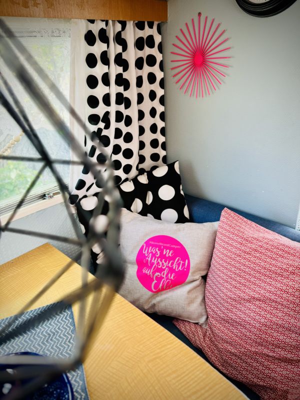 Rosa Kissen auf Sitzecke in Mietwohnwagen Paulina Sonnenschein am Stover Strand