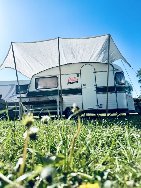 Retro camper with awning at the Stover Strand campsite near Hamburg