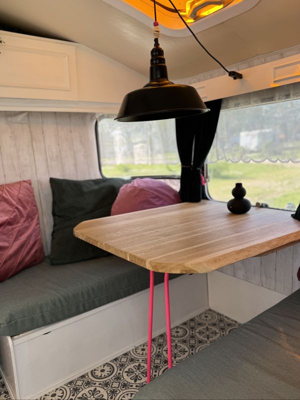 Retro camper with indoor sitting area at the Stover Strand campsite near Hamburg