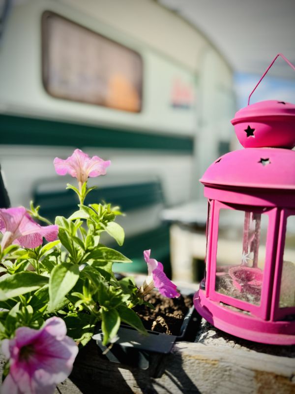 Pink lantern in front of retro camper