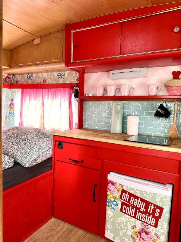 Retro camper with red kitchen at the Stover Strand campsite near Hamburg