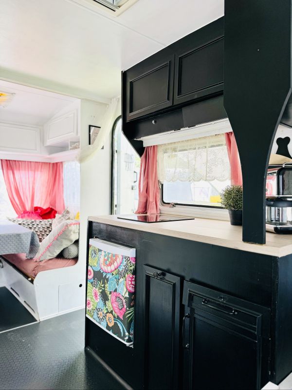Retro camper with black, fully equipped kitchen for Elbe camping near Hamburg