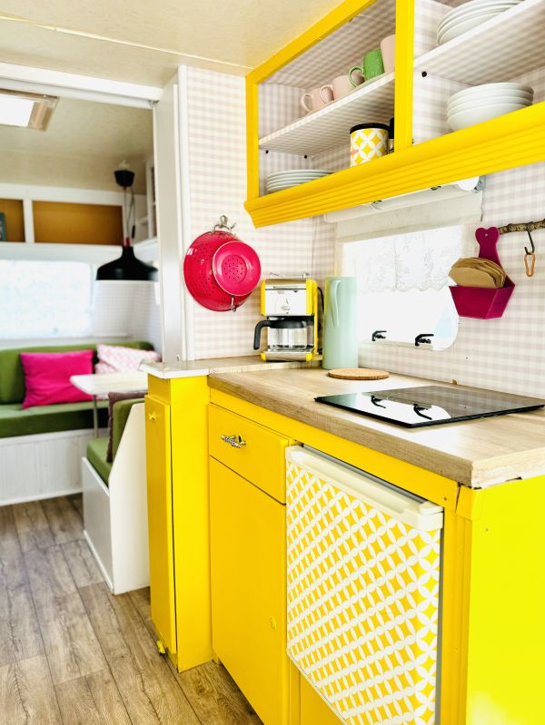 Retro camper with yellow kitchen and equipment at Stover Strand camping