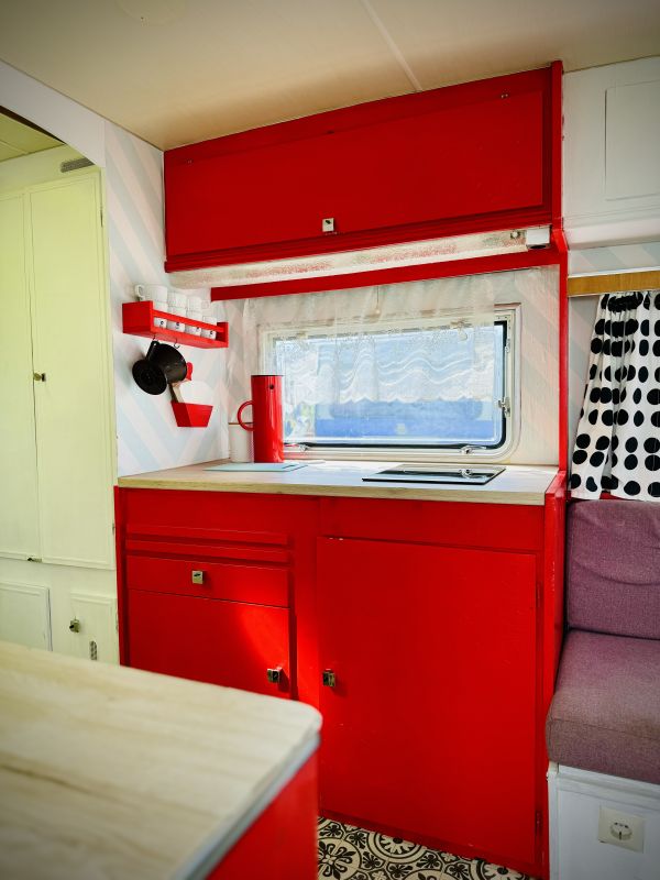 Retro camper with red kitchen and sitting area on Stover Strand Camping