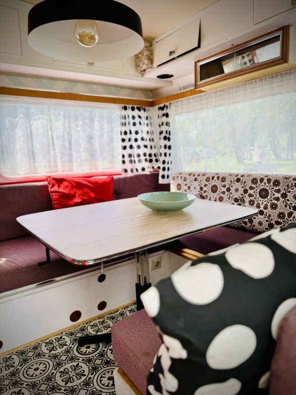 Retro camper with indoor sitting area at the Stover Strand campsite near Hamburg