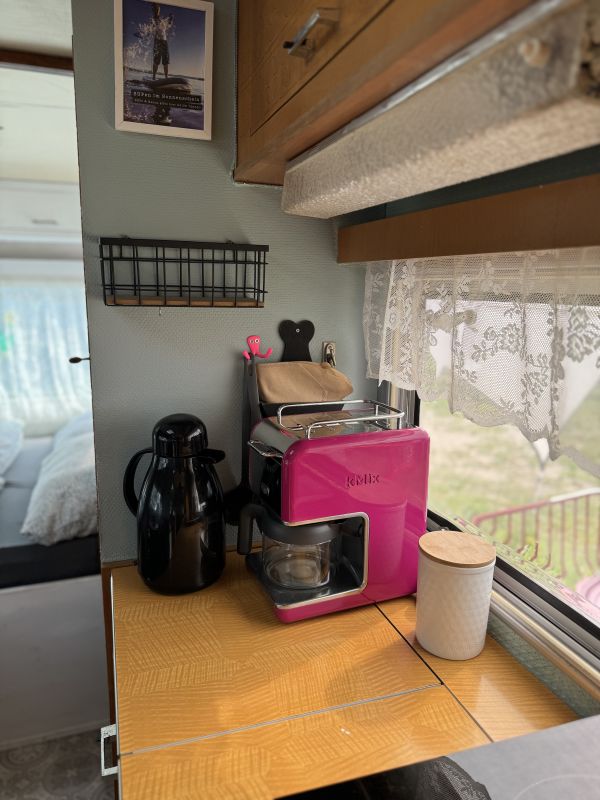 Retro Camper with pink coffee maker at Stover Strand caravan park near Hamburg