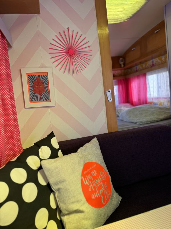 Retro caravan with indoor sitting area and double bed at the Elbe campsite