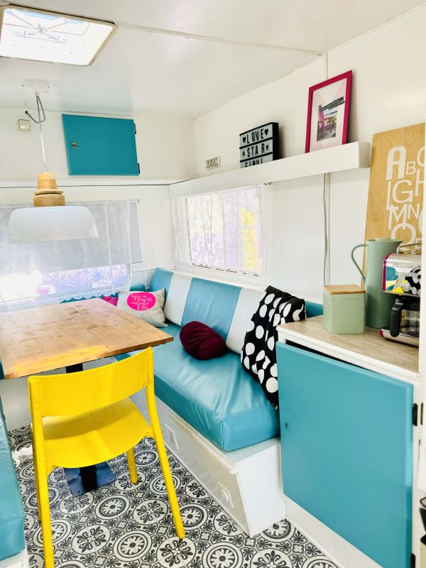 camper with a colorful sitting area in turquoise at Stover Strand Camping