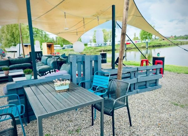 Cozy pallet furniture and Elbe view at Stover Strand Camping near Hamburg