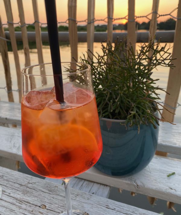 Enjoying an Aperol at sunset on a houseboat at Stover Strand